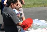 A parent signs one of the three commemorative posters.